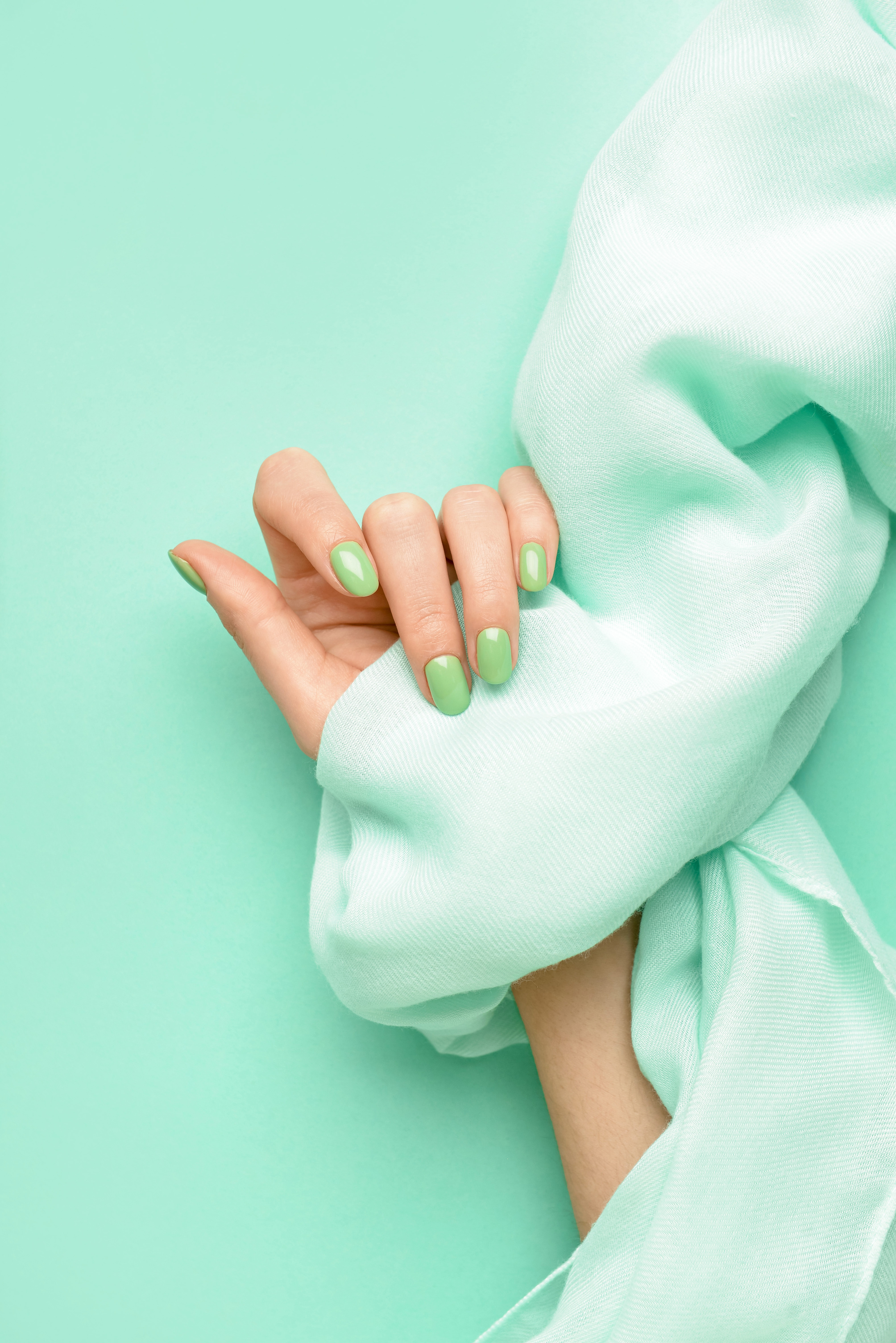 Female Hand with Beautiful Manicure and Scarf on Color Background